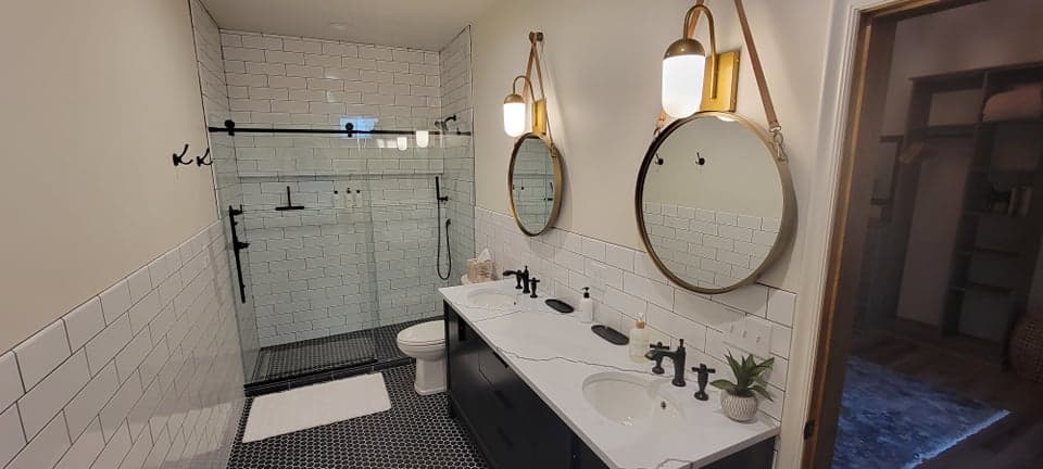 Spotless double-vanity bathroom with round mirrors after a MonaCo deep clean